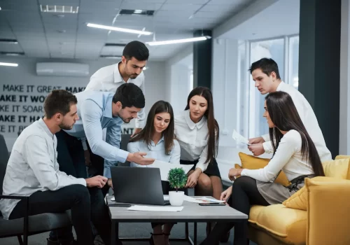 guy-shows-document-girl-group-young-freelancers-office-have-conversation-working